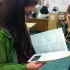 Junior CarmenRose Fiallo flips through the 2014-2015 course guide.