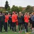 The track team finishes its warm-up by clapping and yelling "Cards!" at a home meet against Aloha on April 16.