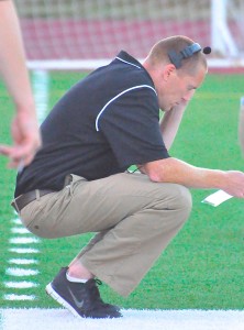 Grimes looks over his playbook during the football team's 41-26 loss to Wilson on Aug. 30.