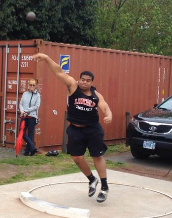 Karl Sanft throws the shot put in the meet against Aloha.