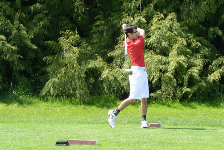 Varisty golfer Ben Stickney hits his tee shot on the first hole at the Langdon course.