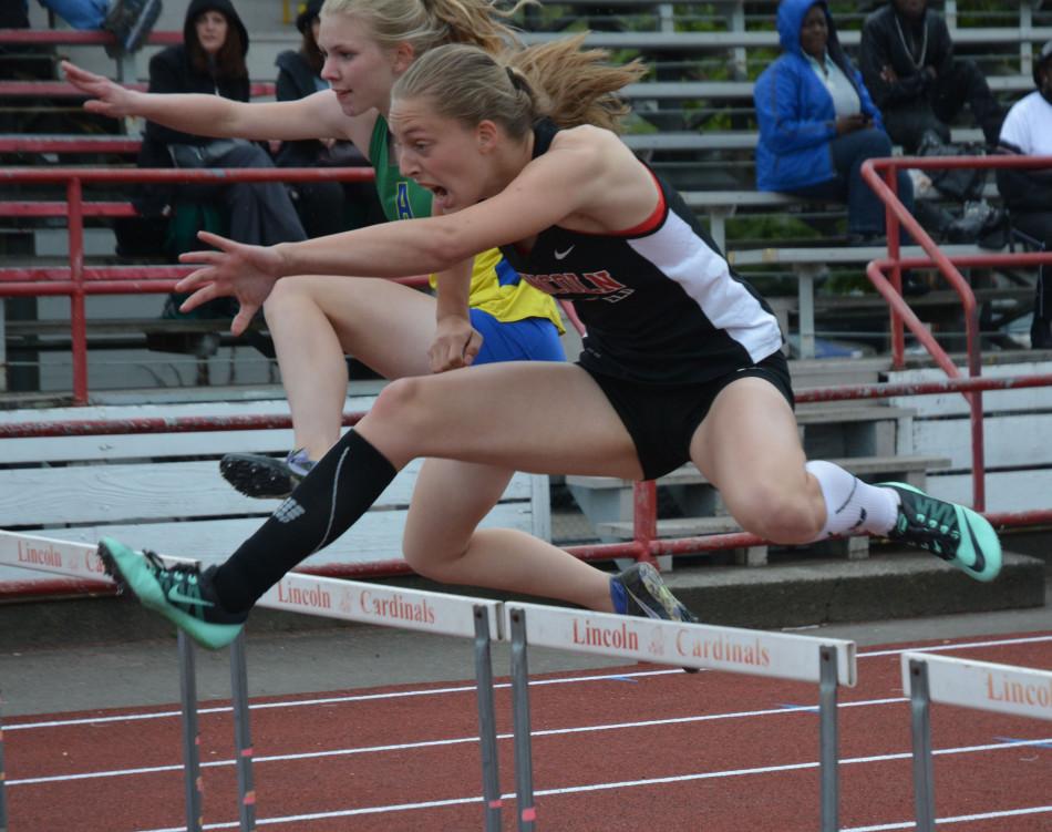 Senior Adrianna Coates runs the 300-meter hurdles.