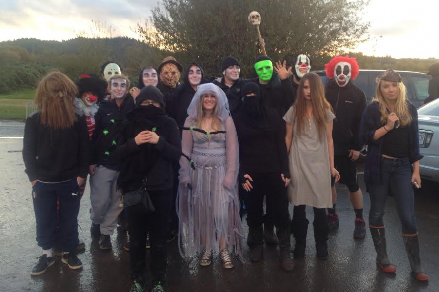 Snowboard and football team members gather in preparation to scare visitors to the corn maze at Kruger Farm Oct. 26.