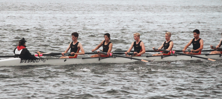 Sammy Gold, sophomore (second rower from the the front), Charlie Hay, sophomore (third from the front), and Spencer Webb, senior (fourth rower from the front) propel their 3v boat to the finish