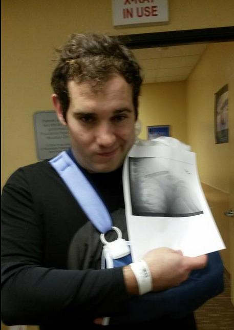 Coach Jesse Nicola, with a sling to hold his arm in place, shows an x-ray of the misplaced screw in his collarbone plate stemming from an injury at Mt. Hood Meadows. 