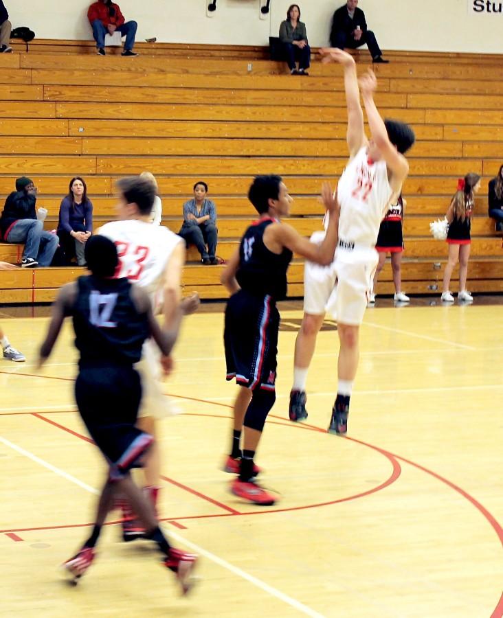 Senior guard Trent Callan goes up for one of his seven 3-pointers in the game with Madison Jan. 12. Callan ended the game with 26 points.