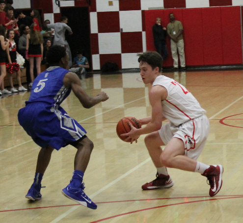 Senior Trent Callan fakes out a Grant defender as the Cardinals beat the Generals 49-34 in the final home game Feb. 20.