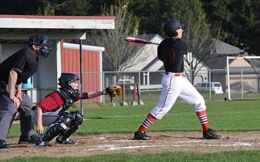 Zane Mills knocks out a hit as the freshmen glide to a 21-1 victory over Madison April 7.