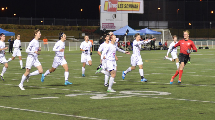 The team circles the field in celebration after a goal from junior Carson Graham.