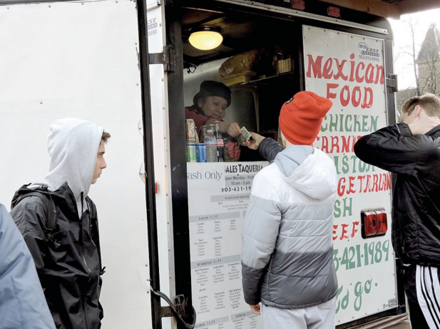 Junior Jake Poole buys his lunch at a Mexican food cart downtown near Lincoln.