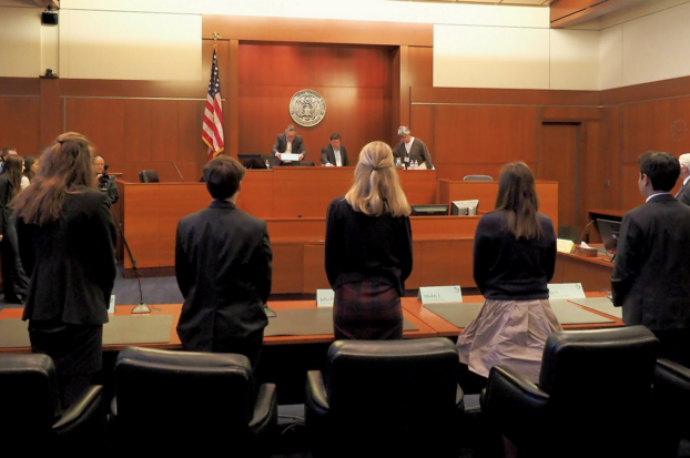 Members of the Constitution team begin to give their prepared speech to the audience in the courtroom.