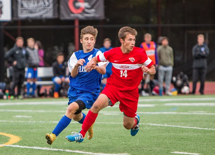 Senior Joey Resnick holds off a Grant attacker during a league match.