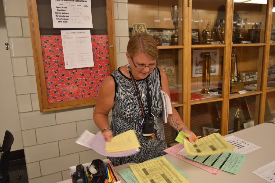 Ginger Taylor, the new curriculum vice principal, helps students with their schedules outside the counseling office.