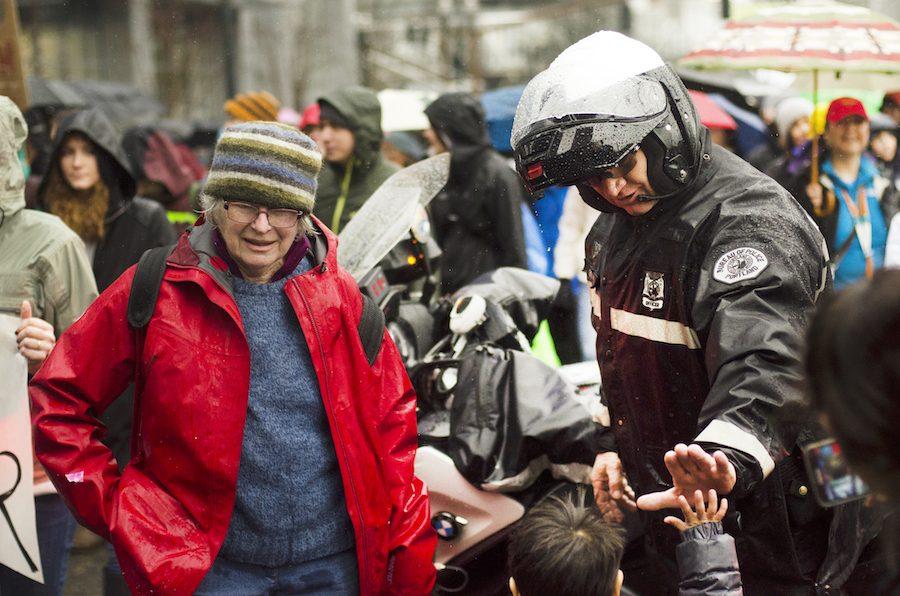 A Portland Police officer high-fives a young marcher at the Portland Womens March Jan. 21.