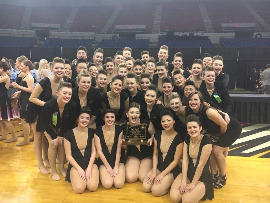 The team celebrates with their trophy after the state competition March 18.