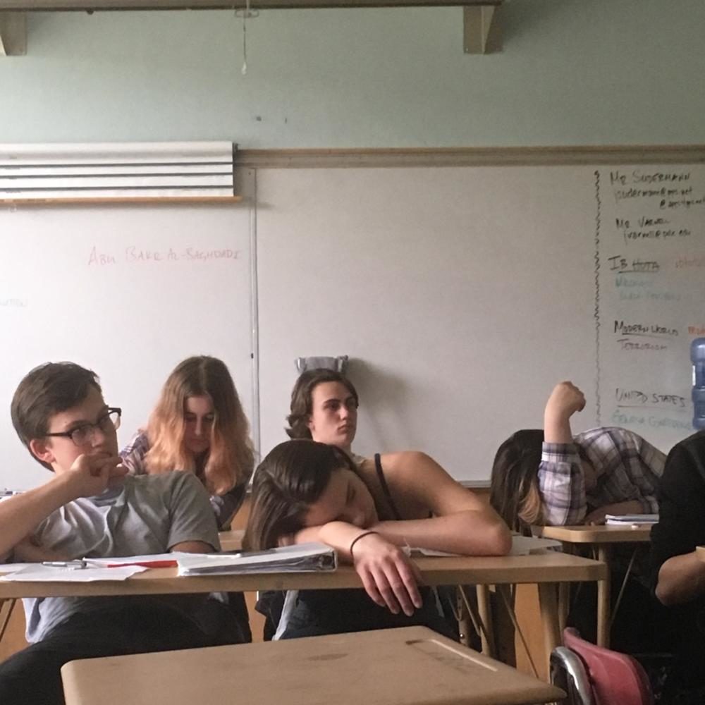 Sophomore Teal Scheffler (center) dozes off in class on April 19. Fatigue is a common issue in Lincoln classrooms and often results from sports.