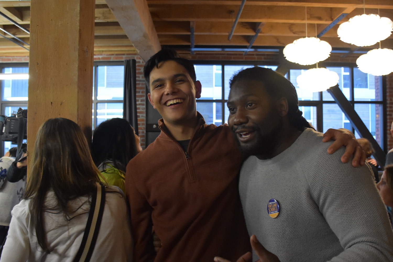 Sophomore Raja Moreno, who spearheaded student advocacy efforts for the measure, hugs Walter Robinson II, the campaigns engagement coordinator, at the election watch party.