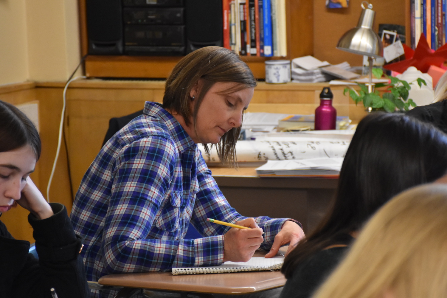 Social studies teacher Julie ONeill takes notes during the Teach-In May 17.