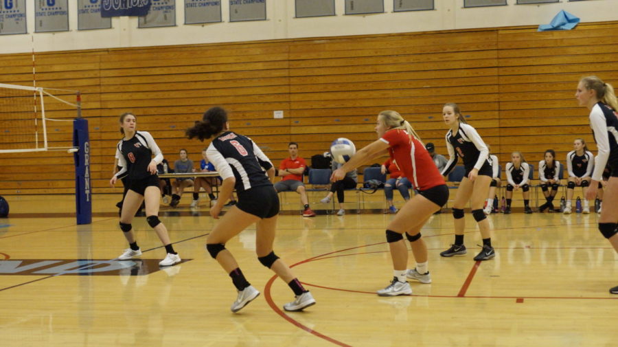 Junior Grace Zilbert (center) plays a ball during a 3-1 victory at Grant on Oct. 11.