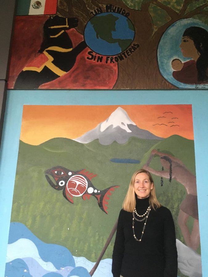 Principal Peyton Chapman stands in front of a
mural that illustrates Lincoln’s committment to
a global education. Chapman would like this
commitment to extend to the rest of the building
in the rebuilt Lincoln.