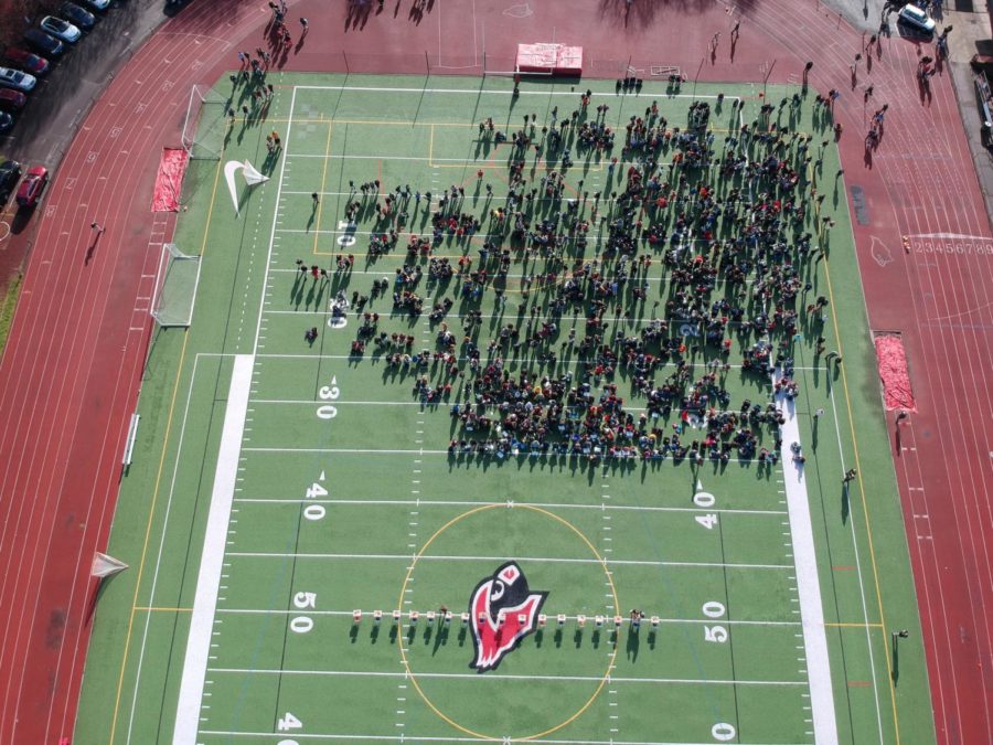 Students gather on the field to pay respect for the 17 students who lost their lives in Parkland, Florida on March 14.