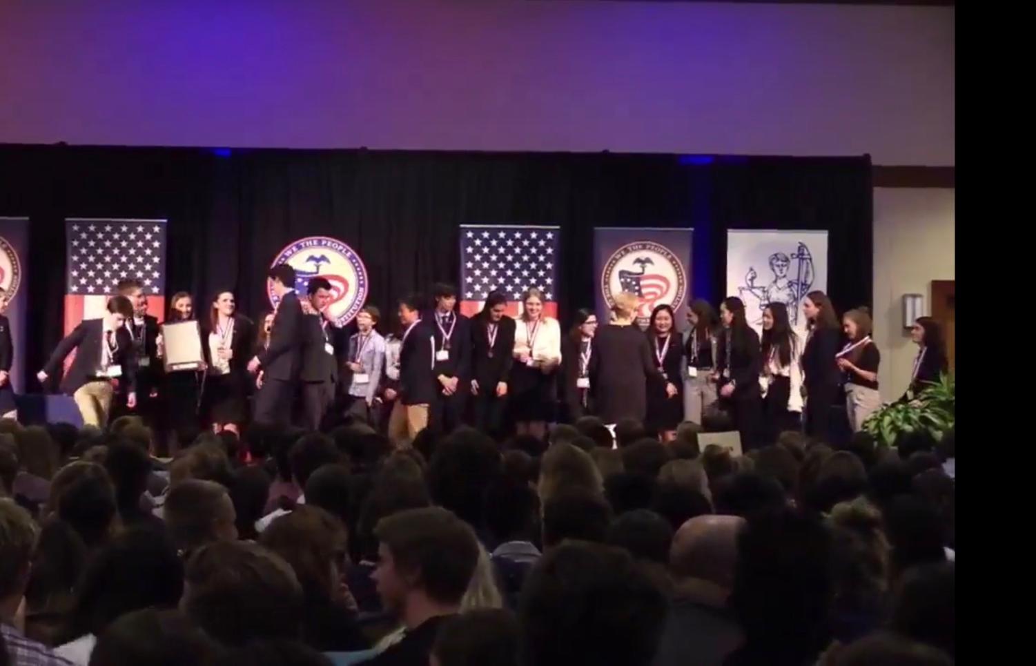 Lincoln's Con Team celebrates on stage after placing third at Nationals in Washington, D.C. on April 30.