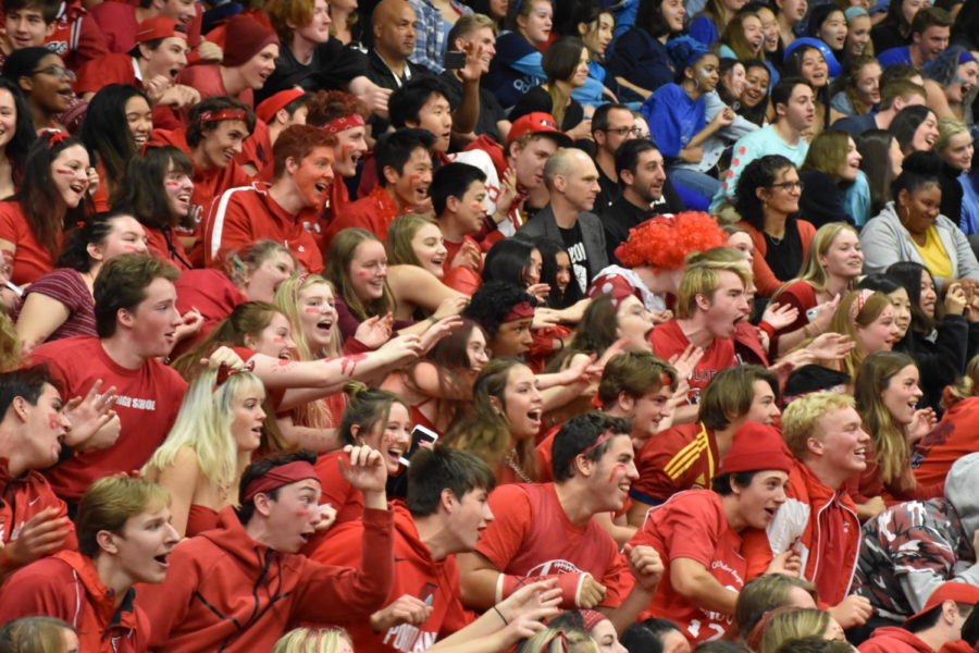 Students do the rollercoaster celebration during color wars assembly.