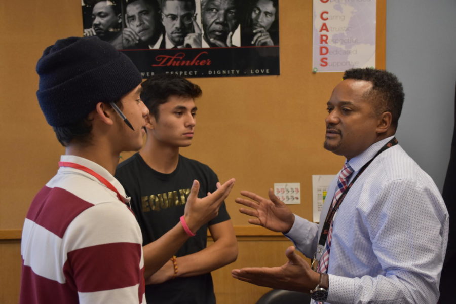 Vice Principal McGee talks with senior Andre Gonzales and junior Avi Kabir. While his new role gives
him an office, McGee still takes time to talk to students in the hallways.