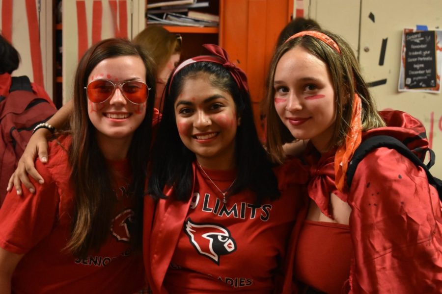 Sydney Laxson (visuals editor), Sagarika Ramachandran (editor-in-chief) and Kayla Rae (managing print editor) pose in classic senior red for color wars, and
have been working together since their freshmen year on the Cardinal Times.
