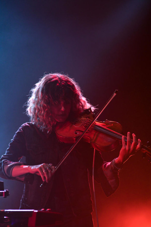 Violinist, Lisa Molinaro, plays onstage for the band Modest Mouse. 