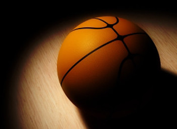 A basketball sits on the court. Photo by Ticket Club is licensed under CC BY-SA 2.0