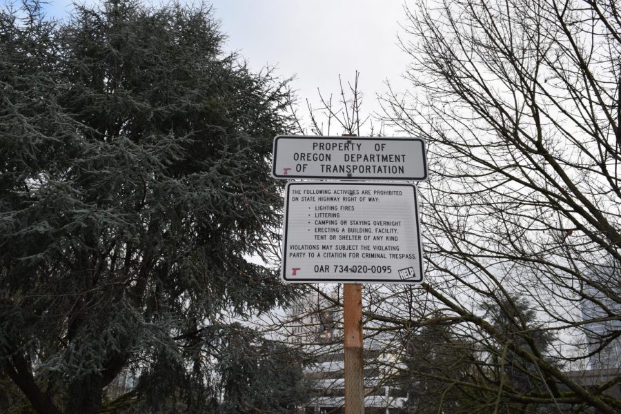 Signs are posted along NW 15th stating regulations that houseless citizens must abide to.