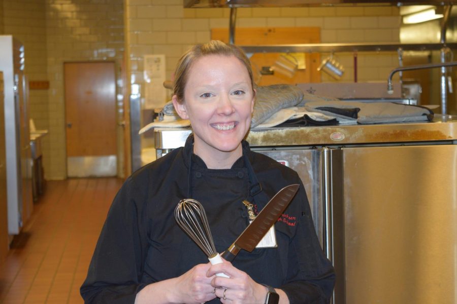 Chef Melanie Hammericksen poses in the kitchen, also the culinary arts room.