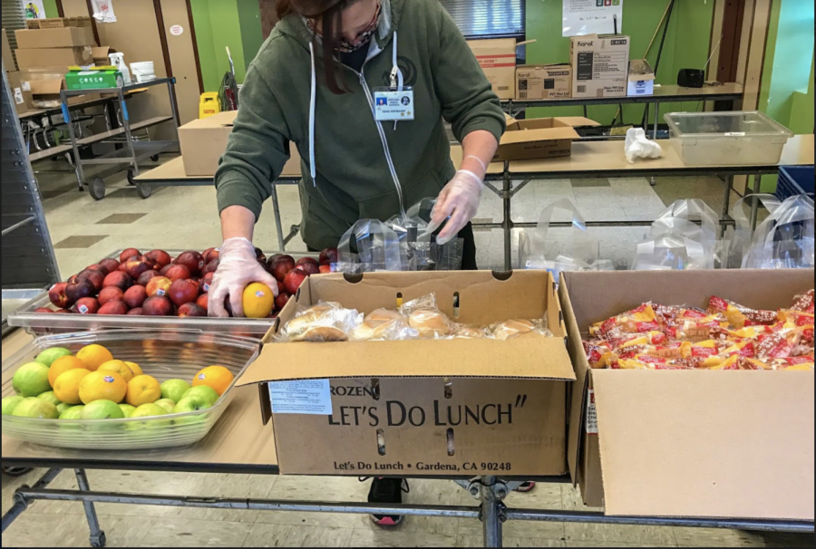 Nutrition Service employees pack meals at Cesar Chavez Elementary. Meals are similar to what students would receive for lunch if they were in the physical building. 