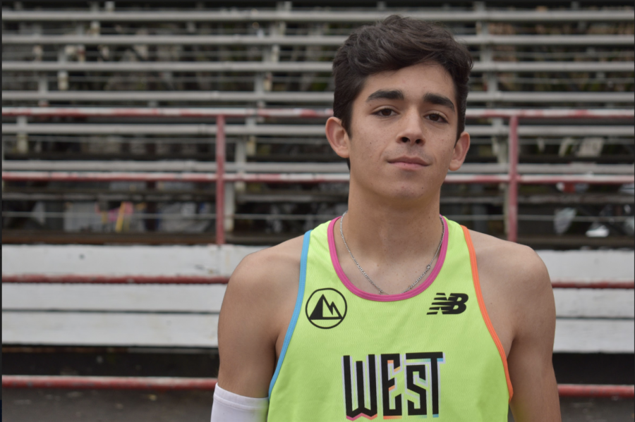 Senior Mateo Althouse stands in front of the Lincoln bleachers last winter. Althouse recently committed to Georgetown University for cross country.