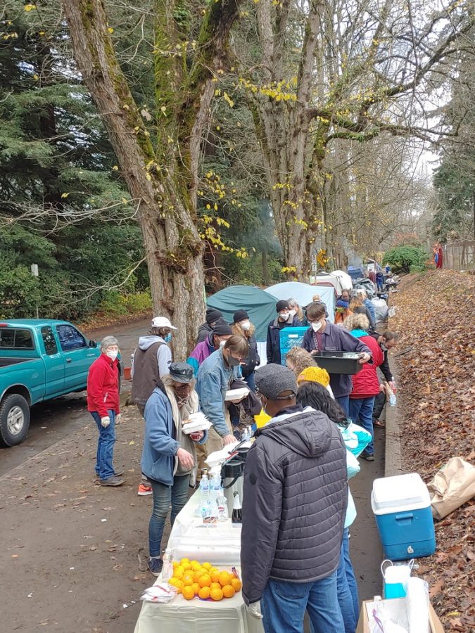 Houseless Portlanders line up to receive food from local activists. The safe park program may provide food in a similar way, but now funded by the city as opposed to activist groups.