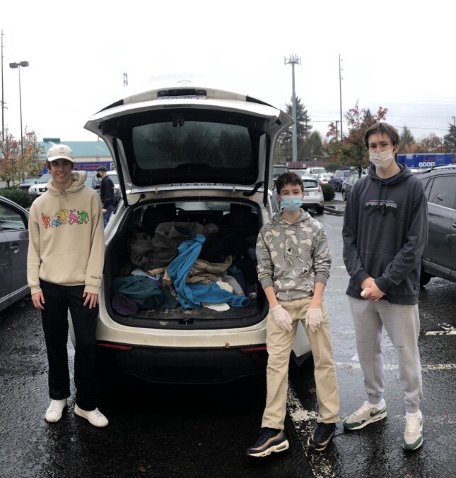Juniors Jeremy Hannah, Jimmy McCartan and Ian Kenyon with the clothes they bought from Goodwill.
