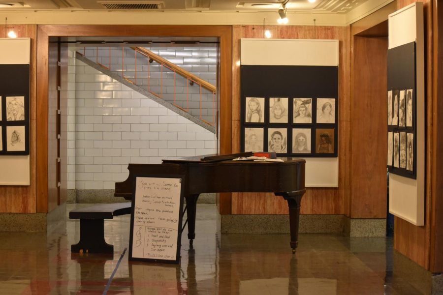 The Lincoln piano sits, unoccupied, in the gallery space in front of the auditorium. This gallery has brought students together through music for decades.