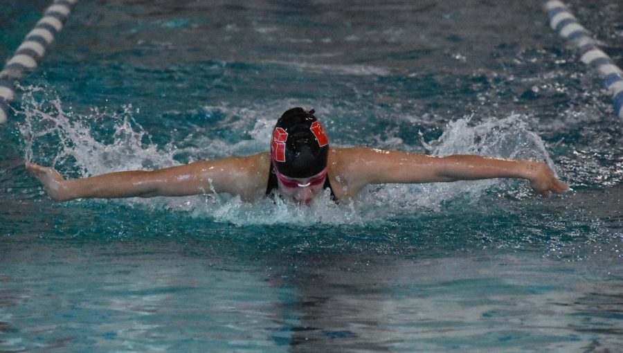 Lucy Rush competes in the 100-yard butterfly final and takes home the first place medal, becoming a district champion in the event and advancing to State.