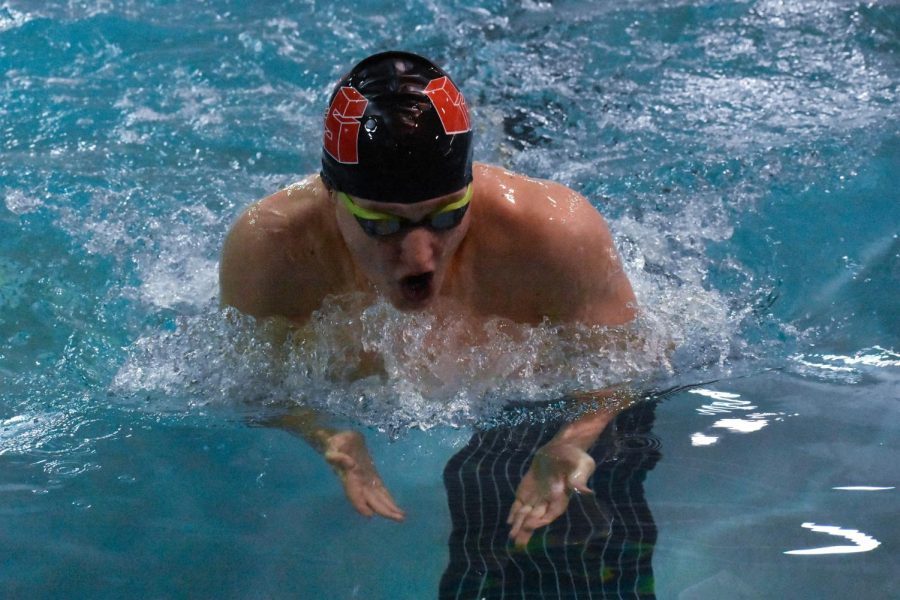 Lucas Williams swims in the 100-yard breastroke final. Williams placed second in the event. Williams fast time got him a wildcard entry into the state-level meet. Senior Cameron Chen also competed in the final, placing third.