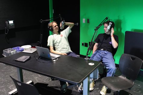 Seniors Henry Reuland and Thomas Kenyon utilize the new green room for their Sports Mania podcast. The green room is currently being used for podcasting and will be used for audio engineering and broadcast journalism in the future.
