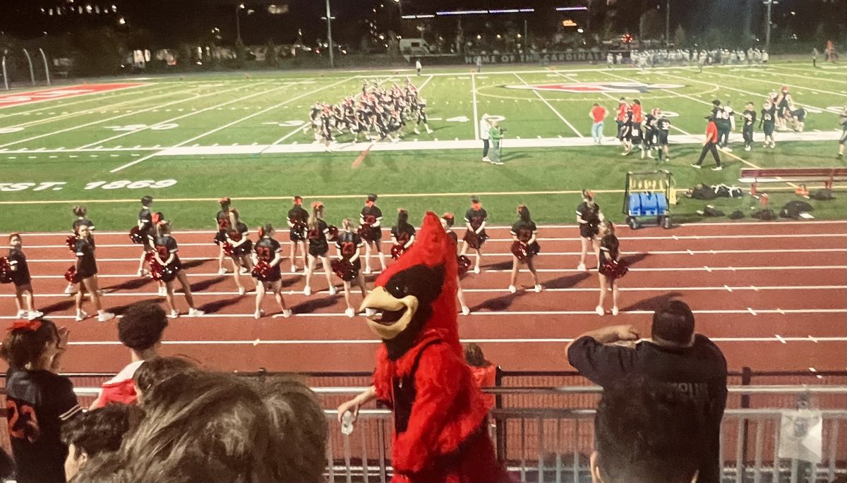 The+Lincoln+Cardinal+mascot+entertains+the+crowd+in+front+of+the+student+section+at+the+varsity+football+game+on+Sept.+8.