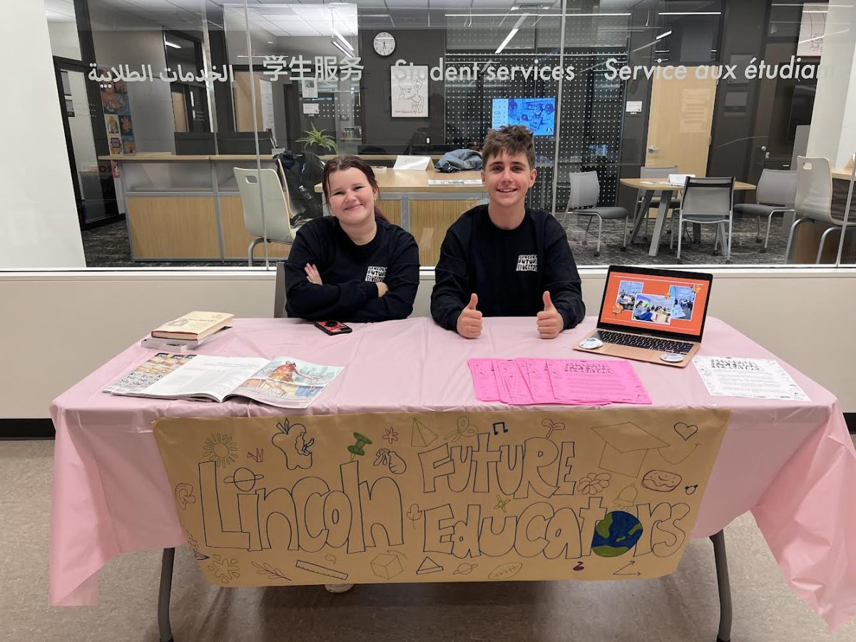 Seniors Mathias Clift and Lola Kovel advertise the Future Educators class at Back to School Night. Clift and Kovel will be the first Lincoln Future Educator CTE completers after finishing their third year.
