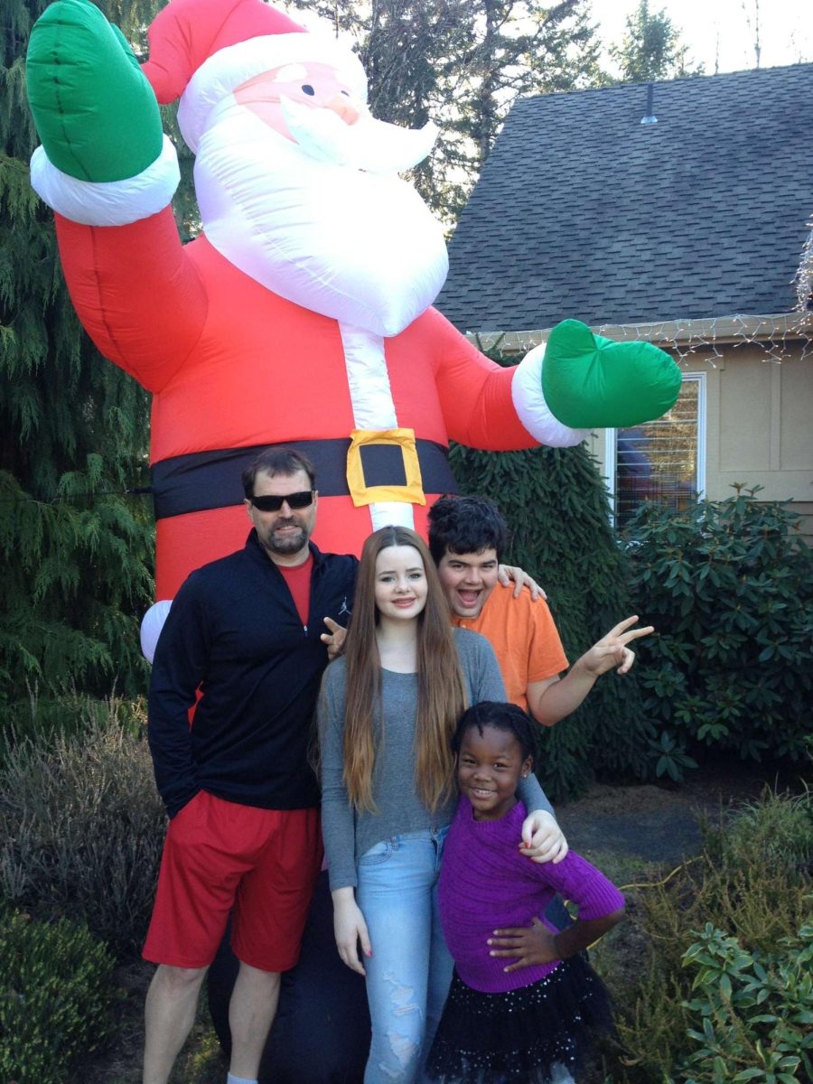 Zahara Hindlin and her family pose by the 20-foot Santa in their yard that is blown up annually.