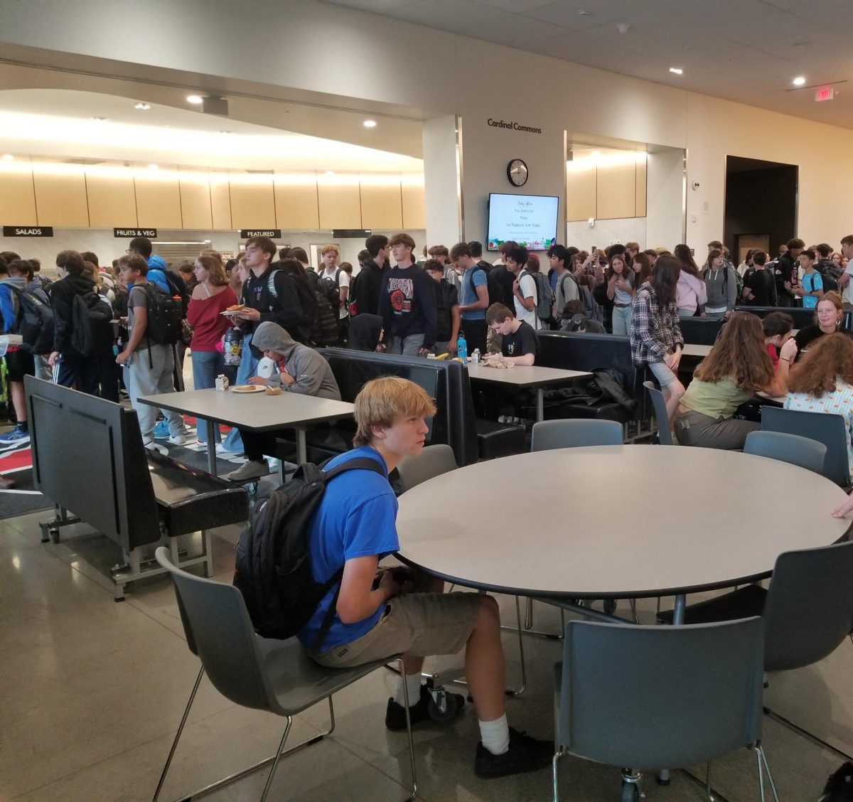 Students are waiting in line for lunch. Administrators say more students are staying on campus now that lunch is free.