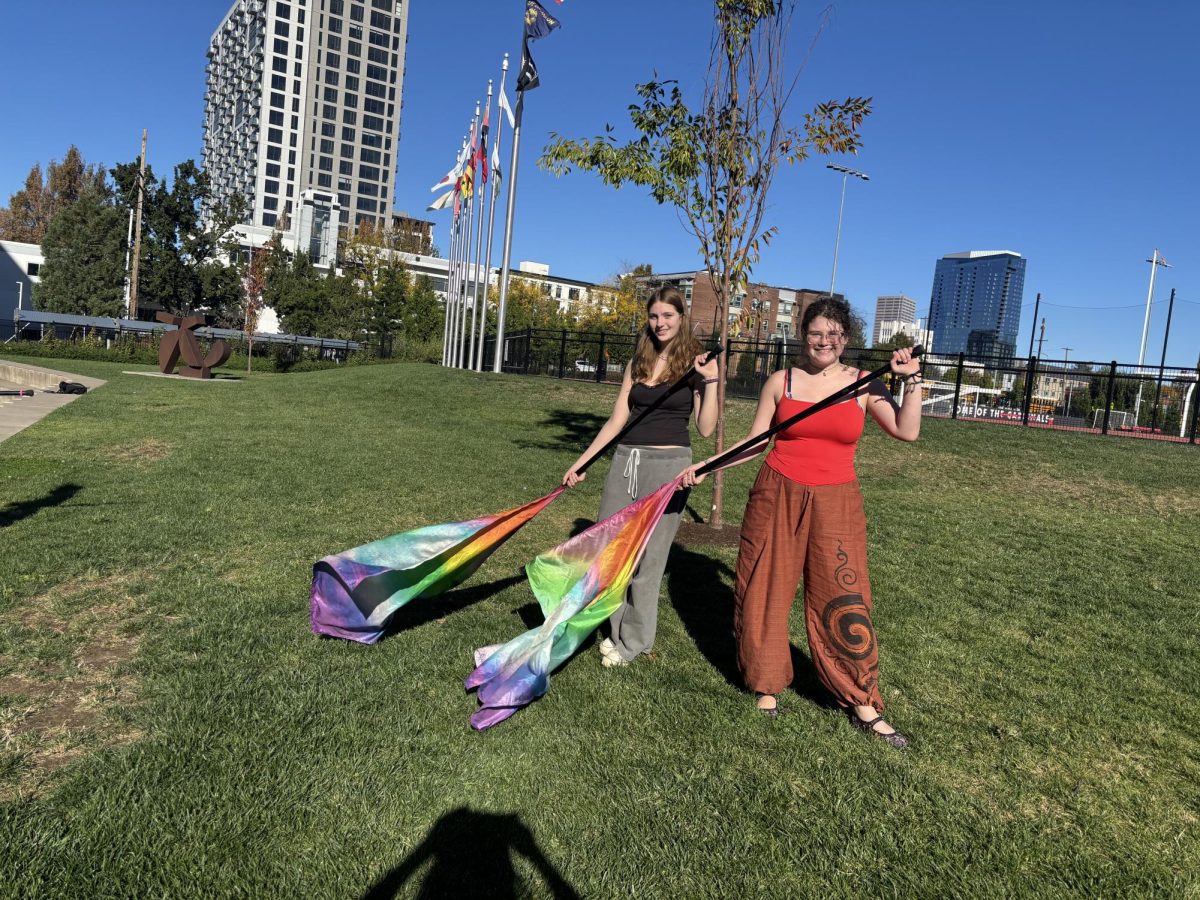 Members of color guard, junior Adelaide Alifanz and sophomore Eloise Connelly, practice flag tossing after school.
By Hana Fares