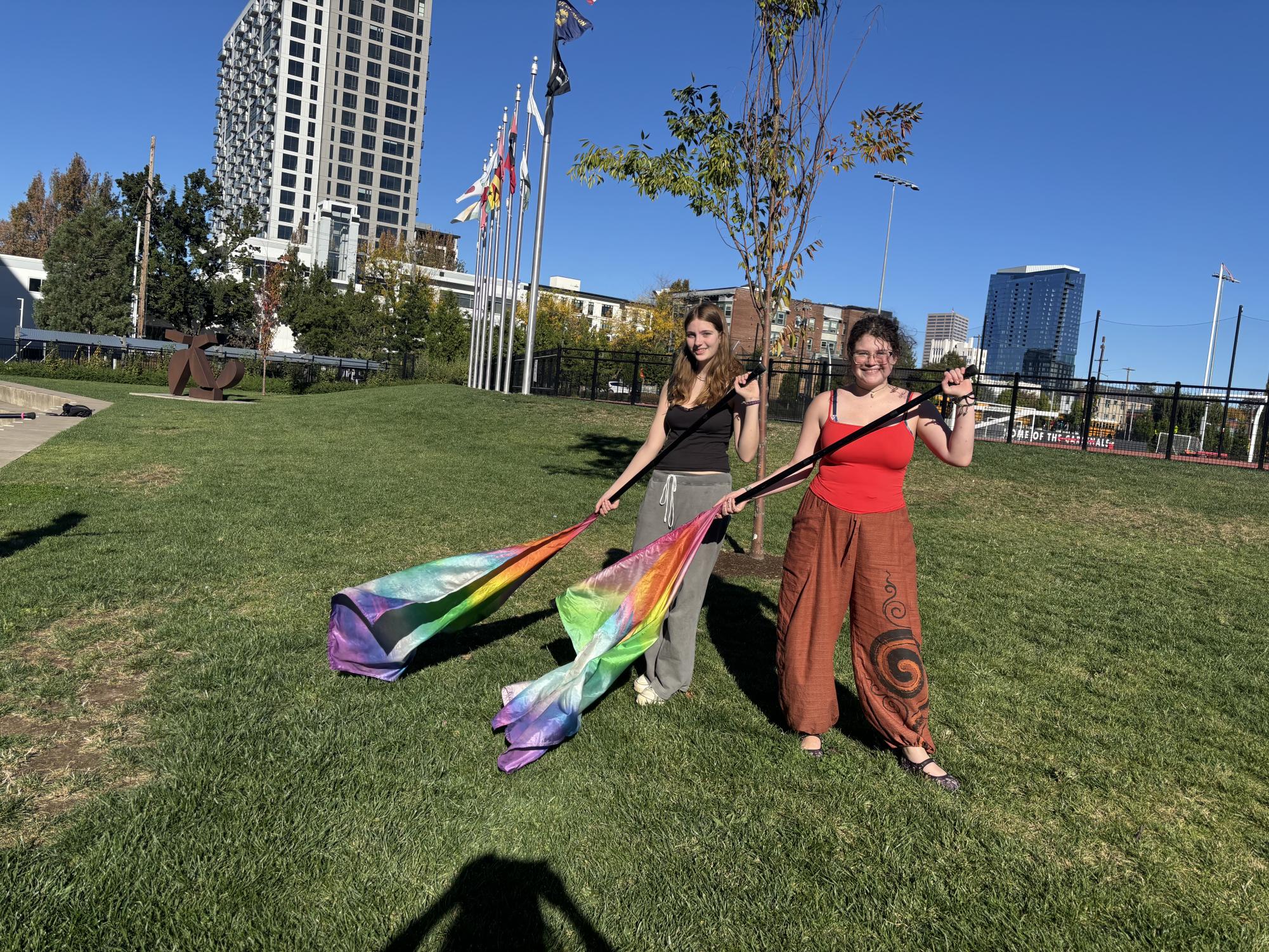 Members of color guard, junior Adelaide Alifanz and sophomore Eloise Connelly, practice flag tossing after school.
By Hana Fares