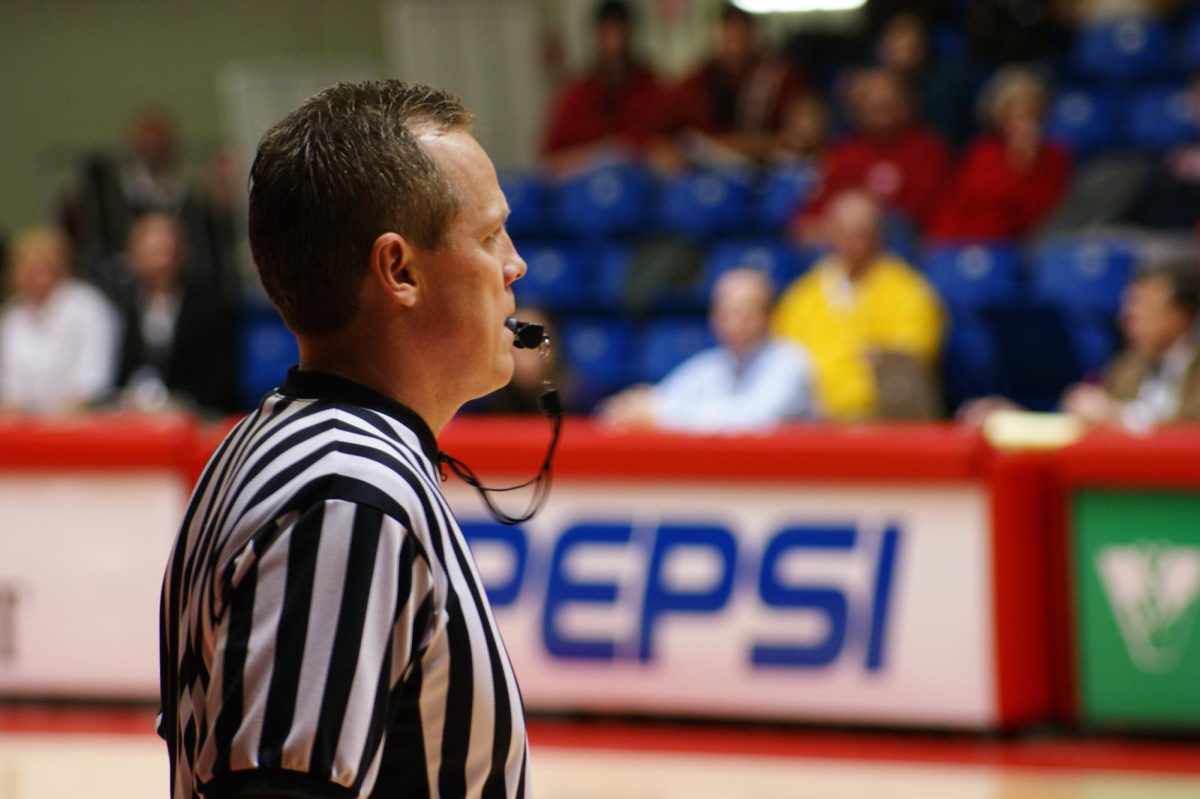 A high school basketball referee stands by ready blow his whistle. Courtesy of Creative Commons