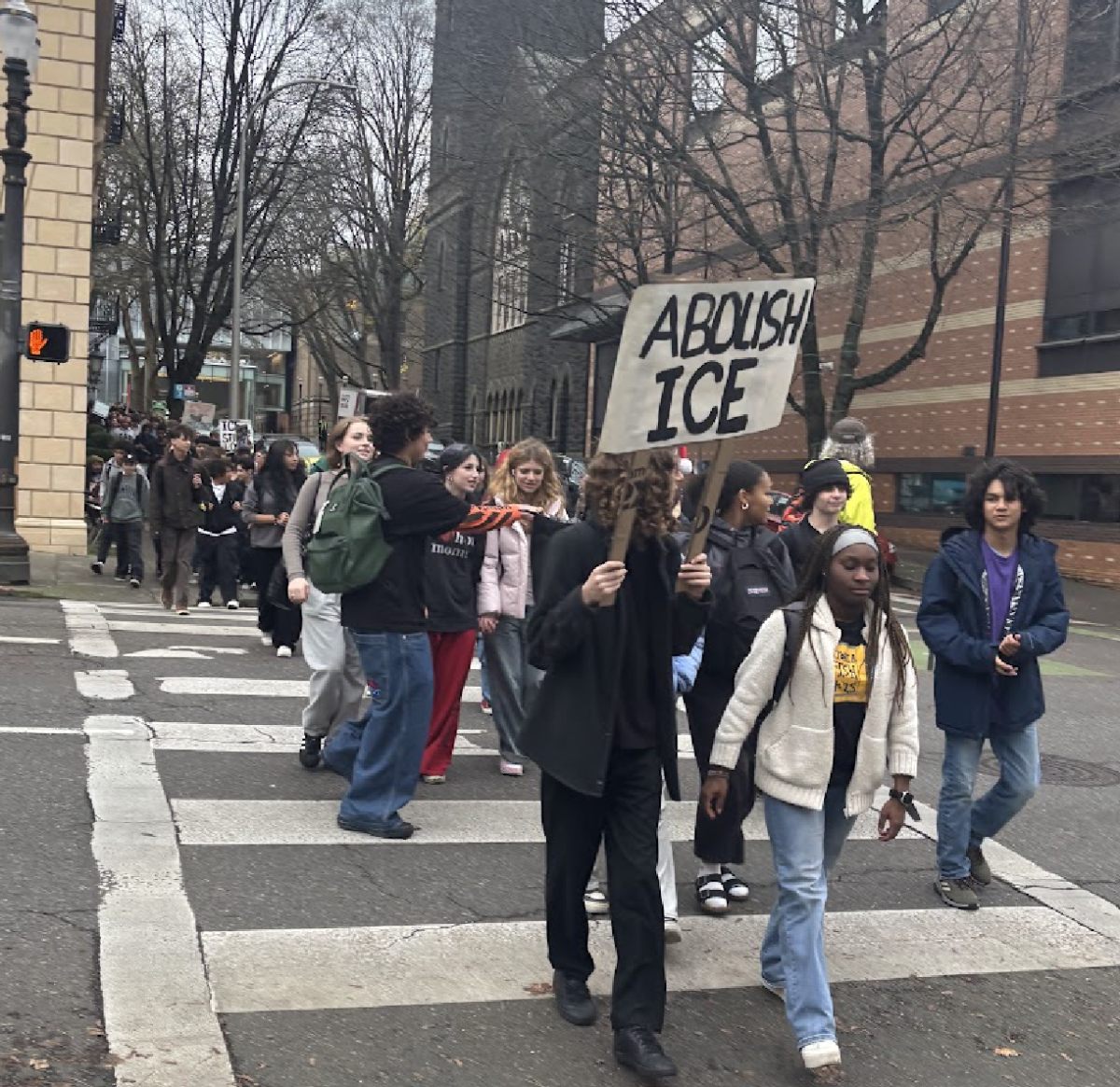 Students yell chants such as “No hate, no fear, immigrants are welcome here” as they walk to City Hall. By Hana Fares